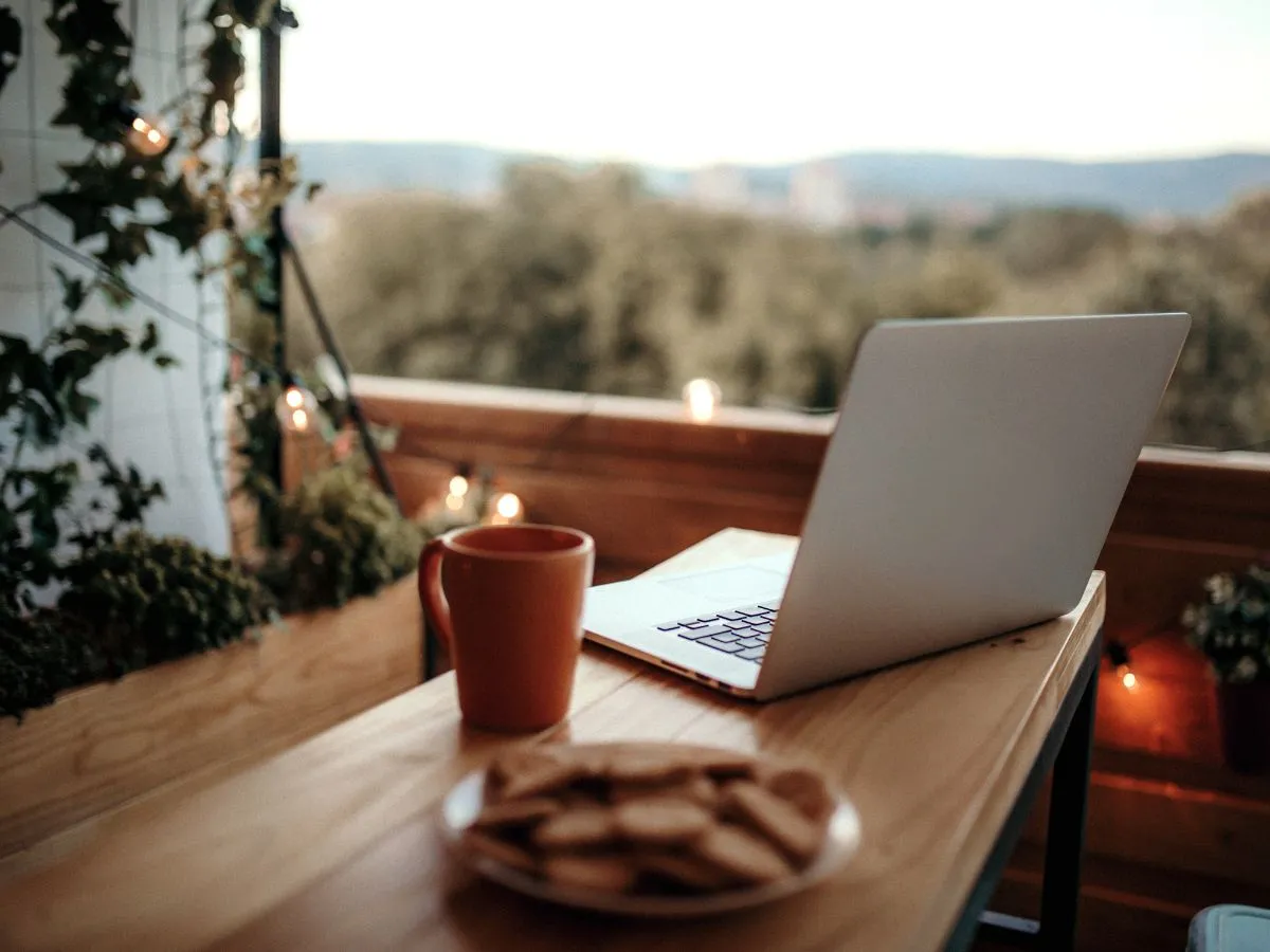coffee cup and laptop on balcony wood table